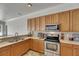 Updated kitchen featuring stainless steel appliances, wooden cabinets, and spacious countertops at 2010 Rutherford Dr, Dover, FL 33527