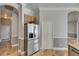 Clean kitchen with stainless steel refrigerator, beautiful tile floor, and a pantry at 2010 Rutherford Dr, Dover, FL 33527