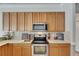 Modern kitchen with wooden cabinets, stainless steel appliances, and spacious countertop at 2010 Rutherford Dr, Dover, FL 33527