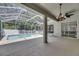 The large screened lanai features a crystal-clear pool, and multiple sliding glass door entrances at 2010 Rutherford Dr, Dover, FL 33527