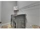 Modern laundry room with a side-by-side washer and dryer and a shelf overhead at 2010 Rutherford Dr, Dover, FL 33527
