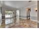 Open-concept living area with tile flooring, patio access, and elegant gray wall accents at 2010 Rutherford Dr, Dover, FL 33527