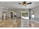 Open living room with tile floors, view of lanai and pool through large sliding glass doors at 2010 Rutherford Dr, Dover, FL 33527