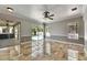 Open living room with tile floors, view of lanai and pool through large sliding glass doors at 2010 Rutherford Dr, Dover, FL 33527