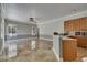 Open-concept living room with kitchen bar, tile flooring, natural light, and neutral paint at 2010 Rutherford Dr, Dover, FL 33527