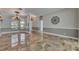 Spacious living room with arched entries, travertine floors, and sophisticated wall decor at 2010 Rutherford Dr, Dover, FL 33527