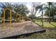 Community playground featuring swings, slides, and a shaded picnic area with lush greenery at 2010 Rutherford Dr, Dover, FL 33527
