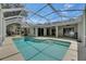 A clear view of the pool and covered patio area with home exterior in the background at 2010 Rutherford Dr, Dover, FL 33527