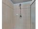 Tiled shower stall featuring a decorative accent border and a modern shower head at 2010 Rutherford Dr, Dover, FL 33527