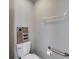 Close-up of a toilet with decorative wall art and a handrail for accessibility at 2010 Rutherford Dr, Dover, FL 33527