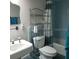 Compact bathroom featuring a white toilet, sink, and shower with a decorative curtain at 2101 Sunset Point Rd # 2305, Clearwater, FL 33765
