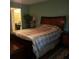 Comfortable bedroom with wood furniture and connecting vanity area with built-in desk at 2101 Sunset Point Rd # 2305, Clearwater, FL 33765