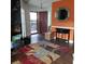 Bright entryway with beautiful hardwood floors, an accent wall, and an inviting front door at 2101 Sunset Point Rd # 2305, Clearwater, FL 33765
