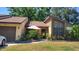 Inviting single-story home with a well-manicured lawn, garden, and neutral-colored brick facade at 2101 Sunset Point Rd # 2305, Clearwater, FL 33765