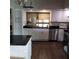 White cabinets accent the kitchen featuring stainless steel appliances and a window bringing in natural light at 2101 Sunset Point Rd # 2305, Clearwater, FL 33765