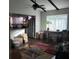 Open-concept living room with exposed beams, wood floors, and access to the kitchen at 2101 Sunset Point Rd # 2305, Clearwater, FL 33765