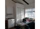 Bright office with a desk, cabinet, shutters, and a large closet creating a functional workspace at 2101 Sunset Point Rd # 2305, Clearwater, FL 33765