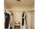 Walk-in closet with shelving and a chair provides ample space for storage at 2101 Sunset Point Rd # 2305, Clearwater, FL 33765