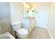 Bathroom featuring a vanity with granite counters, tiled floor, mirror, and a toilet at 2211 Harrison Dr, Holiday, FL 34691