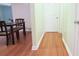 Hallway leading to dining area featuring wood floors and neutral paint at 2211 Harrison Dr, Holiday, FL 34691