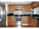 Well-equipped kitchen featuring stainless steel appliances, granite counters, and ample cabinet space at 2211 Harrison Dr, Holiday, FL 34691