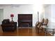 Cozy living room featuring a piano, armchairs, and a glass table on hardwood flooring at 2211 Harrison Dr, Holiday, FL 34691