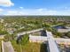 Aerial view showcasing the buildings within a community setting and a lovely lake at 2221 Swedish Dr # 55, Clearwater, FL 33763