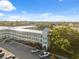 Aerial of building complex, parking lot, mature tree coverage, and blue skies at 2221 Swedish Dr # 55, Clearwater, FL 33763