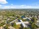 Stunning aerial view of the community near a tranquil lake, surrounded by lush greenery and neighborhood streets at 2221 Swedish Dr # 55, Clearwater, FL 33763