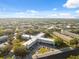 Wide aerial captures apartment complex, landscaping, parking, and adjacent residential areas at 2221 Swedish Dr # 55, Clearwater, FL 33763