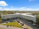 An aerial view of the apartments with parking and lush landscaping at 2221 Swedish Dr # 55, Clearwater, FL 33763