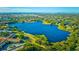 Breathtaking aerial view of a serene lake community with lush green trees and a distant city skyline at 2221 Swedish Dr # 55, Clearwater, FL 33763