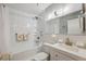 Clean bathroom features white subway tiles, a tub, a shower, and a white vanity with modern fixtures at 2221 Swedish Dr # 55, Clearwater, FL 33763