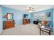 Bright bedroom with blue walls, light carpet, window shutters, ceiling fan, and comfortable furnishings at 2221 Swedish Dr # 55, Clearwater, FL 33763