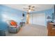 Spacious bedroom features a ceiling fan, soft carpet, ample closet space, and a comfy recliner at 2221 Swedish Dr # 55, Clearwater, FL 33763