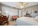 Comfortable bedroom showcasing neutral walls, white closet doors, ceiling fan, and vintage accents at 2221 Swedish Dr # 55, Clearwater, FL 33763