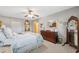 Bedroom showcasing decorative wall mirrors, white bed linens, neutral carpet, and a dark wood dresser at 2221 Swedish Dr # 55, Clearwater, FL 33763