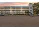 Lovely exterior of the condo building with unique tower feature and large parking lot at 2221 Swedish Dr # 55, Clearwater, FL 33763