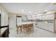 Spacious and bright kitchen with white cabinets, tile floors and center island with seating at 2221 Swedish Dr # 55, Clearwater, FL 33763