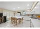 Spacious and bright kitchen with white cabinets, tile floors and center island with seating at 2221 Swedish Dr # 55, Clearwater, FL 33763