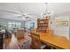 Inviting living room with wood floors, ceiling fan, and elegant chandelier over the wooden dining room table at 2221 Swedish Dr # 55, Clearwater, FL 33763