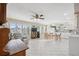 Bright open-plan living room boasts tile floors, a ceiling fan, and natural light from the large windows at 2221 Swedish Dr # 55, Clearwater, FL 33763