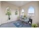 Enclosed sunroom with views, bistro set and nautical themed rug at 2221 Swedish Dr # 55, Clearwater, FL 33763