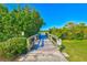 Picturesque wooden walkway amidst lush greenery, leading to scenic views and a peaceful retreat at 2221 Swedish Dr # 55, Clearwater, FL 33763