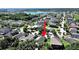 Aerial view of a lakeside community with lush trees, showcasing the home's serene location at 2405 Dakota Rock Dr, Ruskin, FL 33570