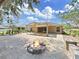 An outdoor brick paved patio with a cozy fire pit provides an inviting outdoor gathering space at 2405 Dakota Rock Dr, Ruskin, FL 33570