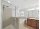 Bathroom featuring glass-enclosed shower, soaking tub, and dual vanities with granite counter at 2405 Dakota Rock Dr, Ruskin, FL 33570