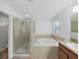 Bathroom featuring glass enclosed shower, soaking tub and granite counters at 2405 Dakota Rock Dr, Ruskin, FL 33570