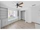 Bright bedroom featuring light wood floors, modern ceiling fan, and custom shelving and storage at 2405 Dakota Rock Dr, Ruskin, FL 33570