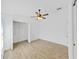 Bright bedroom featuring a ceiling fan, light wood floors, and a closet with shelving at 2405 Dakota Rock Dr, Ruskin, FL 33570